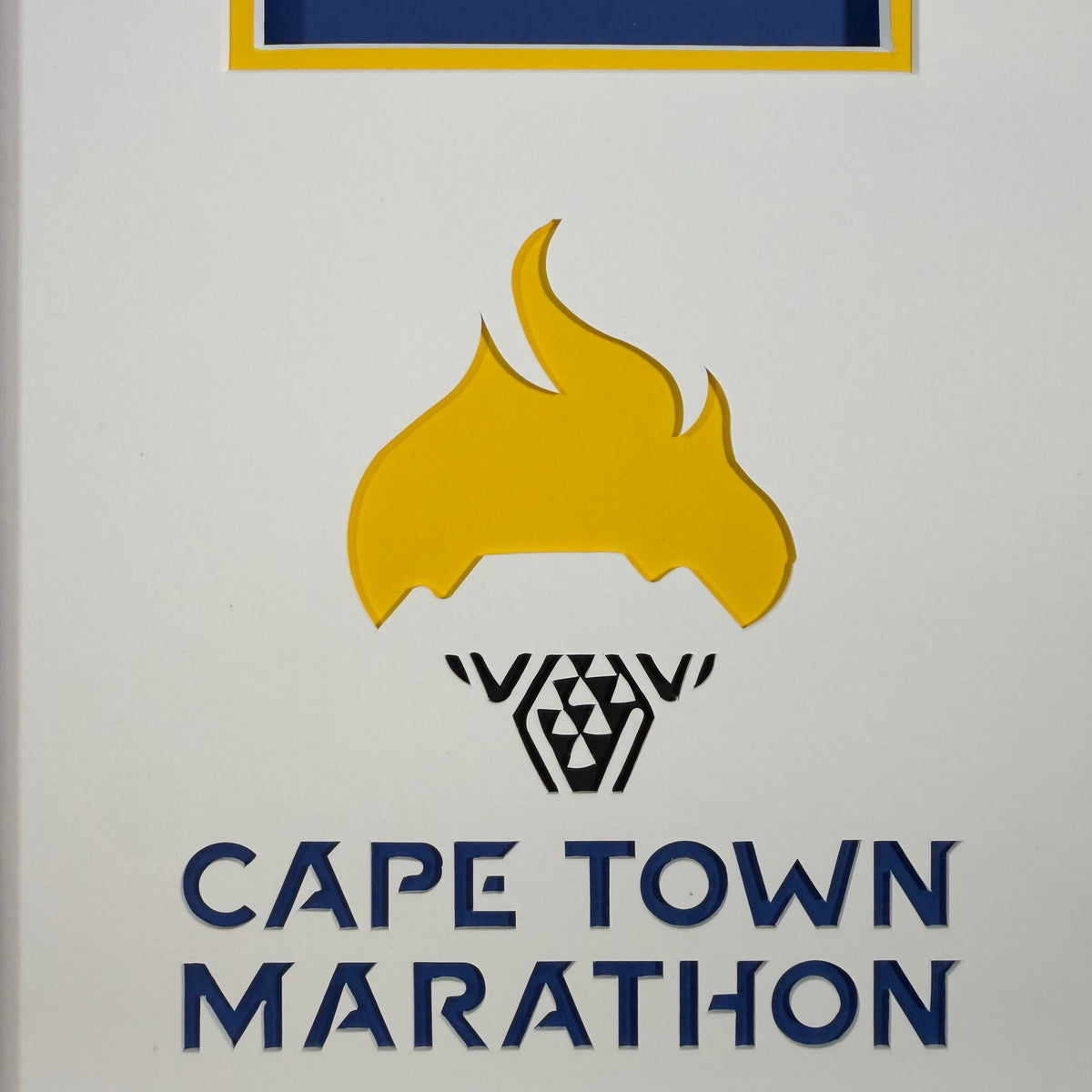 Close-up of the layered yellow flame and Cape Town Marathon lettering cut into the mount by our Valiani mount cutter