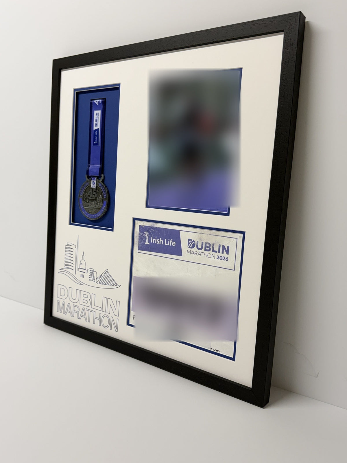 Medal, bib and photo frame seen from an angle